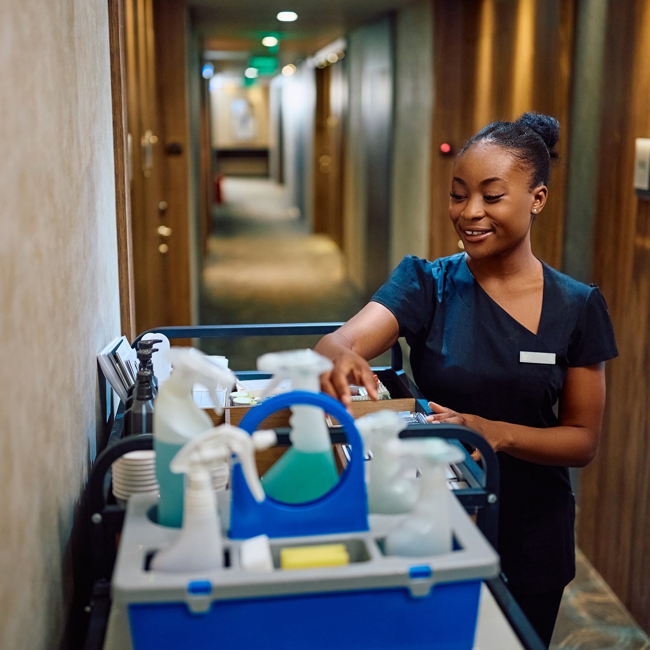 Young happy black woman working as housekeeping staff in a hotel.